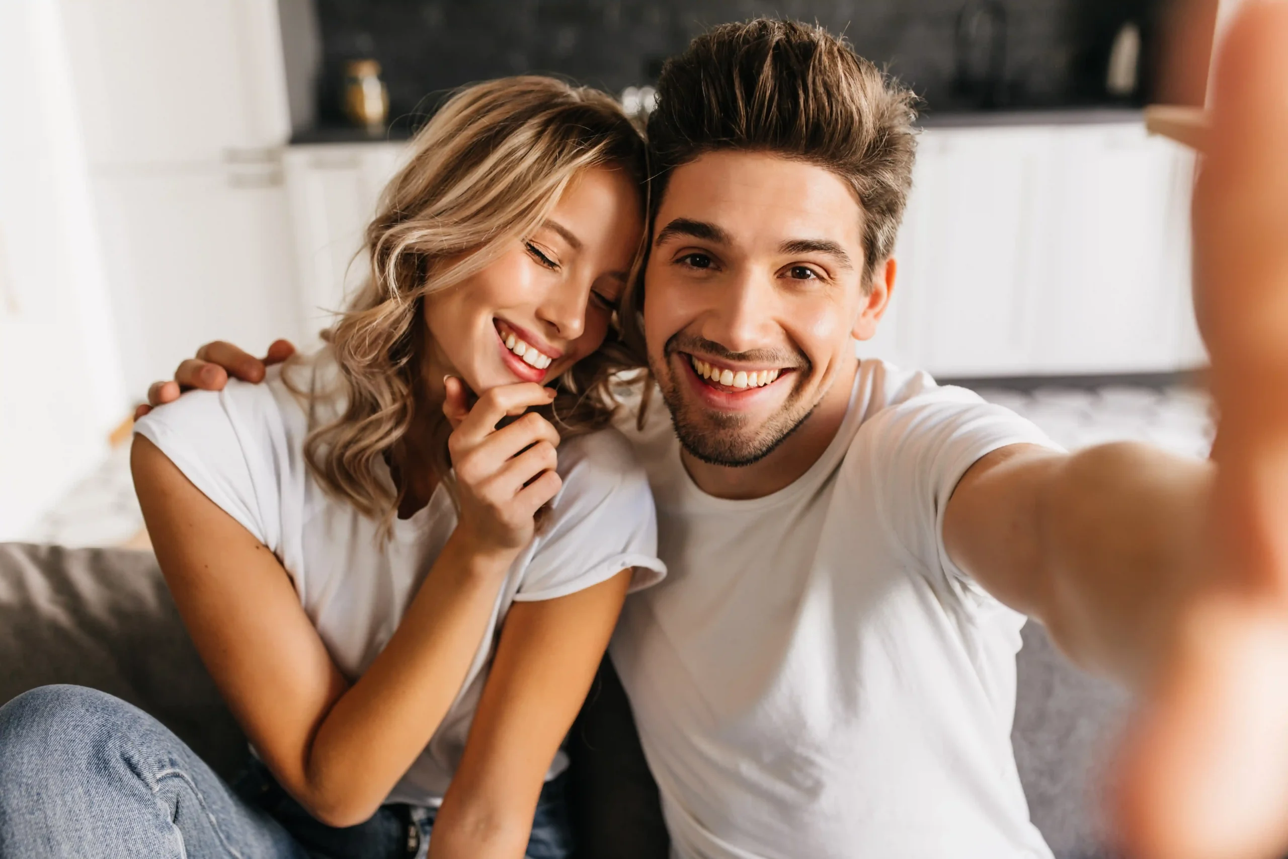 romantic-smiling-couple-making-selfie-home-sitting-sofa-man-his-girlfriend-happily-smiling-with-closed-eyes_7_IMGCentury